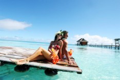 Couple on a pontoon in the Tuamotu islands